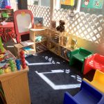 Classroom learning center at Little Tykes with educational toys, books, and child-sized chairs.