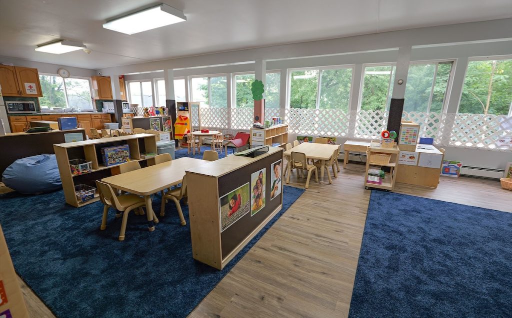 Preschool classroom at Little Tykes in Lodi, NJ, with child-sized tables, learning centers, and large windows.